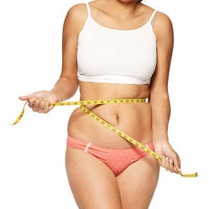 Overweight girl measuring her waist